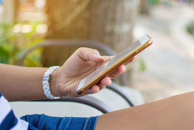 Midsection of woman using mobile phone