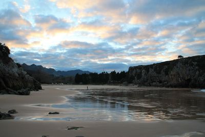 Scenic view of beach against sky during sunset