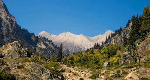 Scenic view of mountains against clear blue sky