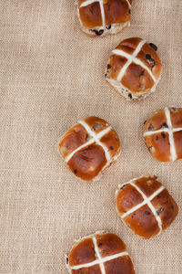 Tasty fresh hot cross buns on rustic surface