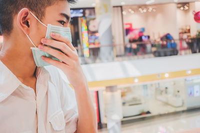 Portrait of man drinking glass at restaurant