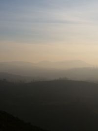 Scenic view of silhouette mountains against sky