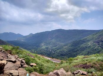 Scenic view of mountains against cloudy sky