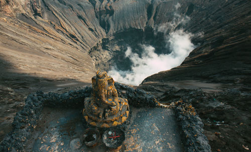 Close-up of ganesha statue against volcanic crater
