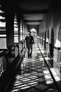 Rear view of man walking in corridor