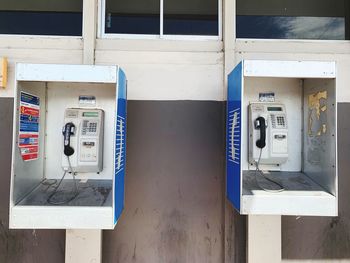 Information sign on wall, phone, street 