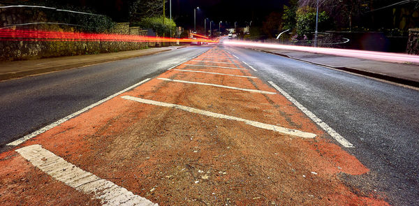 Light trails on road in city at night