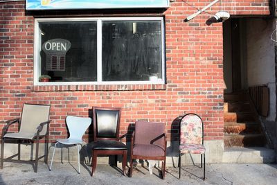 Chairs and table against brick wall