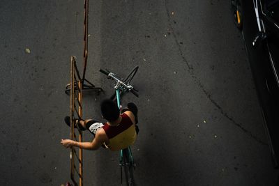 High angle view of woman riding bicycle on road