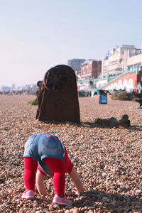 Rear view of girl against clear sky