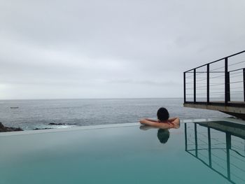 Rear view of young woman in swimming pool