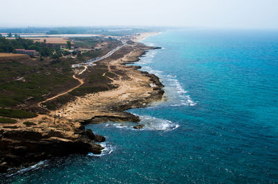 High angle view of sea shore against sky