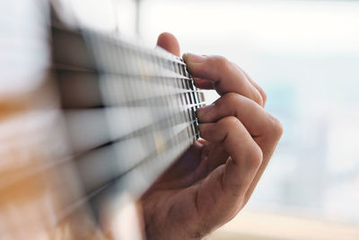 Close-up of hand playing guitar