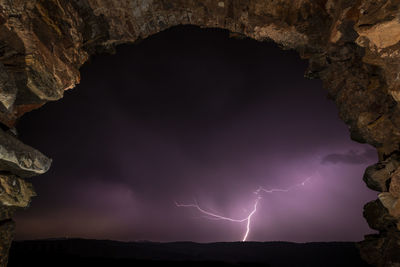 Low angle view of lightning against sky at night