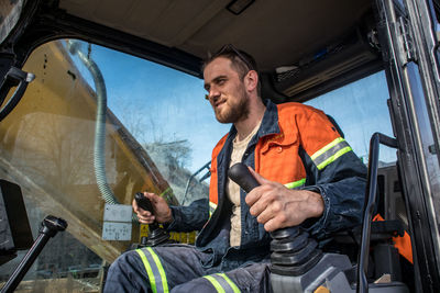 Senior man working in excavator 