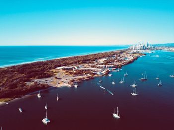 Aerial view of sea against clear blue sky