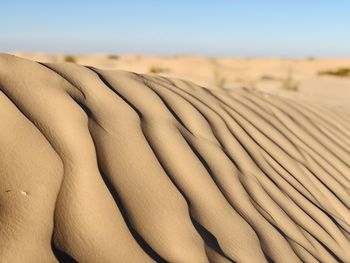 Sand dunes in desert against sky