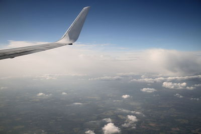 Aerial view of airplane flying in sky