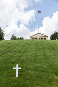 Cross and flag on grassy field