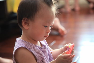 Cute boy looking away while using mobile phone