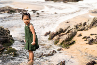 Portrait of girl standing on rock