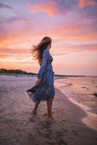 Full length of woman on beach during sunset