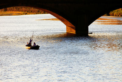 People on bridge over river