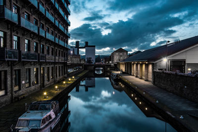 Reflection of illuminated buildings in canal at dusk