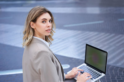 Young woman using laptop at office