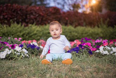 Portrait of cute girl sitting on plants