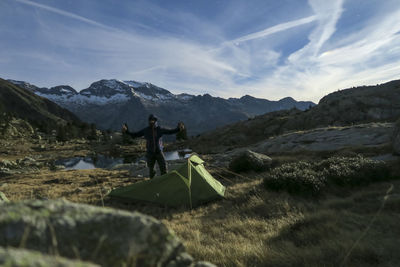 People on mountain against sky