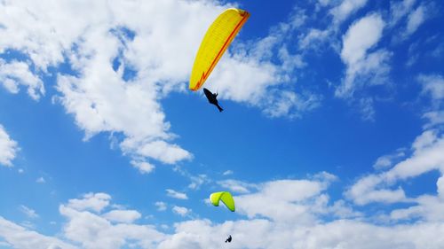 Low angle view of kite flying against blue sky