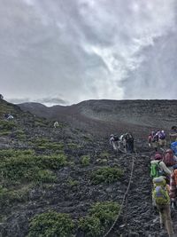 Scenic view of landscape against cloudy sky