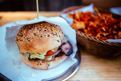 Close-up of burger in paper on table