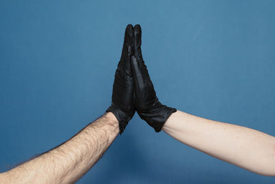 Low section of man against blue background