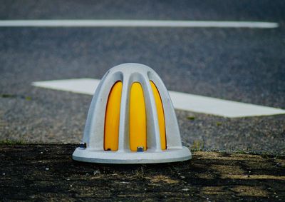 Close-up of yellow cup on table