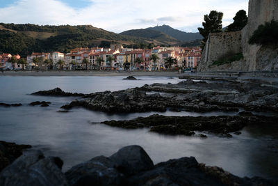 Scenic view of sea and buildings against sky