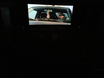 Rear view of man sitting in car window