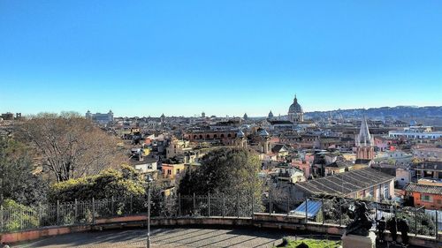 Cityscape against clear blue sky