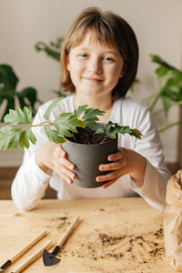 The girl collects soil in peat pots for planting seeds. spring gardening hobby for the whole family.