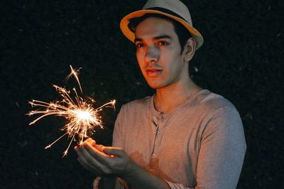 Man playing with sparkler at night