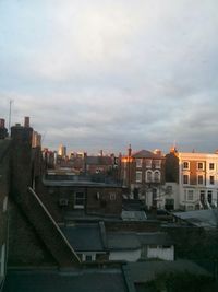 Buildings against cloudy sky