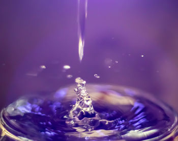 Close-up of water splashing against glass