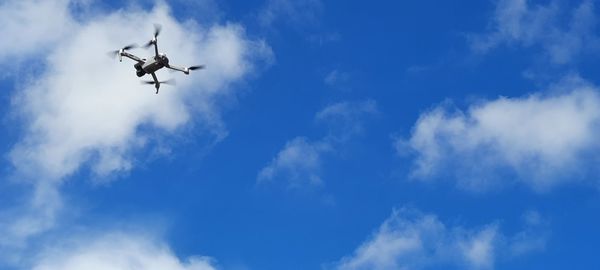 Low angle view of airplane flying in sky