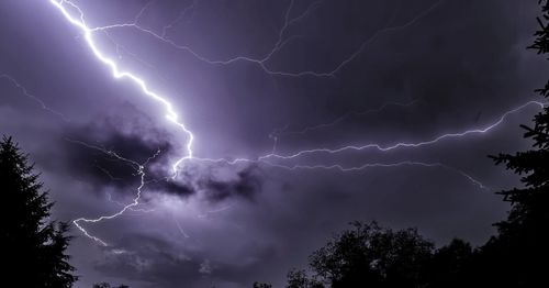 Low angle view of lightning in sky at night