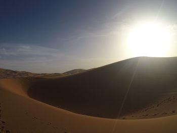 Scenic view of desert against sky during sunset