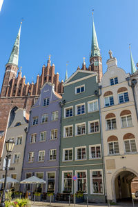 Low angle view of buildings against sky in city