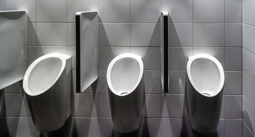 Close-up of urinals in restroom