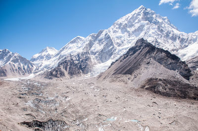 Scenic view of snowcapped mountains against clear blue sky