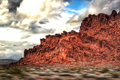 Rock formation on land against sky